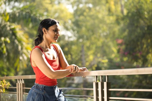 Young woman admiring view at balcony. Here's your july 20 zodiac sign daily horoscope 