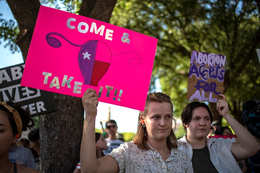 AUSTIN, TX -JUNE 25 : Protesters hold up signs during an abortion-rights rally on June 25, 2022 in A...