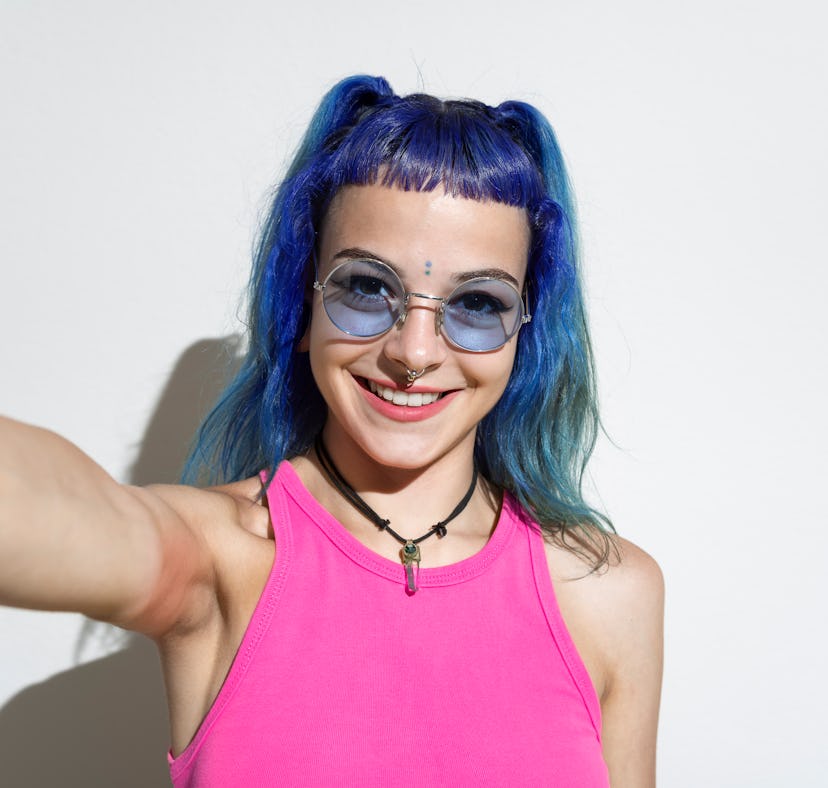A young woman with clear skin who may use tretinoin, TikTok's favorite skin care ingredient, takes a...