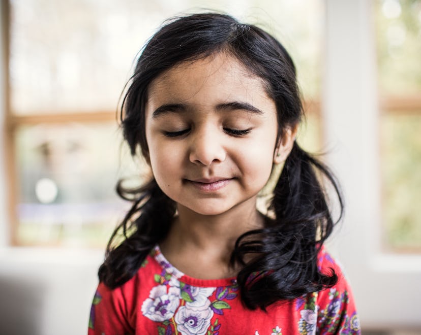 Portrait of a hopeful young girl at home, practicing mindfulness activity for kids