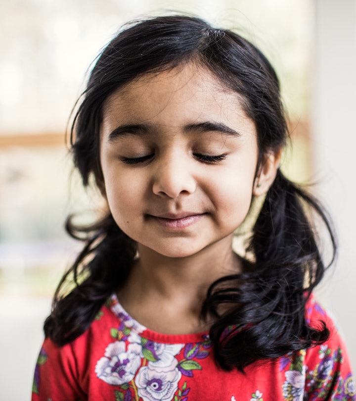 Portrait of hopeful young girl at home, practicing mindfulness activity for kids