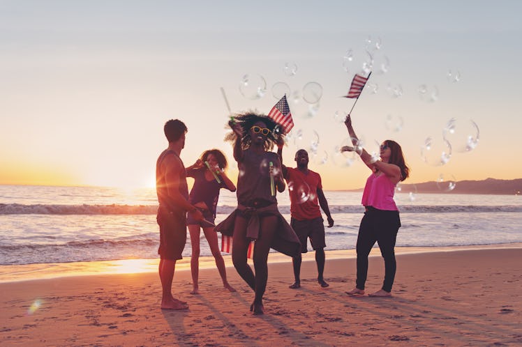 Friends celebrating 4th of July at the beach, California, use 4th of July captions with friends to s...