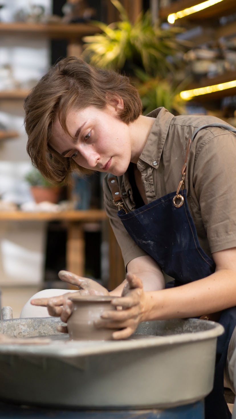 Two women in a pottery studio. Get creative during Leo season 2022 by starting new art projects or f...