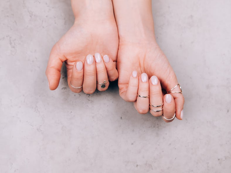 A woman with a glazed doughnut nails manicure.