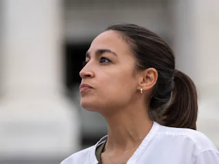 WASHINGTON, DC - AUGUST 03: Rep. Alexandria Ocasio-Cortez (D-NY) talks with a reporter as she protes...
