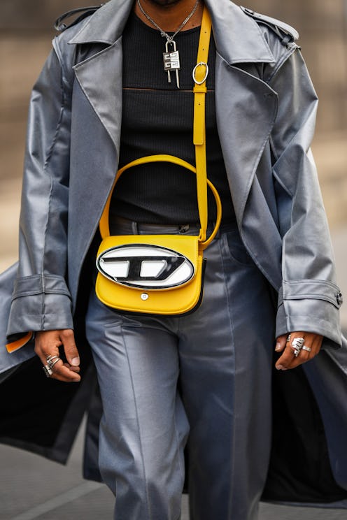 PARIS, FRANCE - JUNE 26: Theo Kimbaloula wears a silver chain padlock pendant necklace from Givenchy...