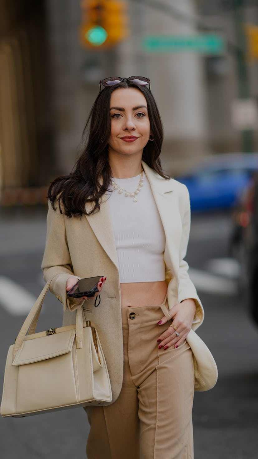 NEW YORK, NEW YORK - FEBRUARY 12: Kendall Becker wears black sunglasses, gold earrings, gold large c...