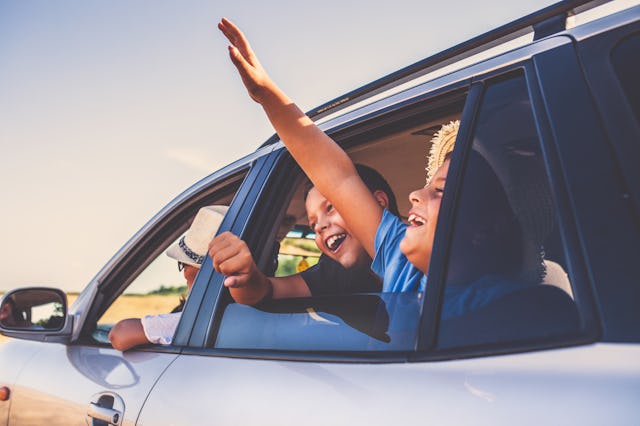 Family Driving In  Car On Countryside Road Trip