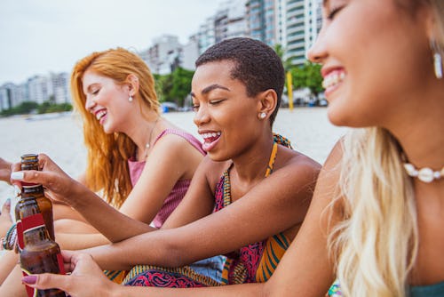 Shoot of group of young women having fun on the beach. Here's how leo season affects each zodiac sig...
