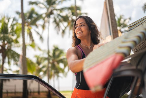 A girl gets ready to go surfing. The july 2022 new moon in leo will affect these three zodiac signs ...