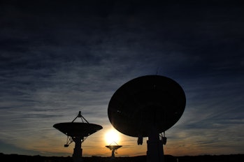 Photo of radio antennae against a sunset sky