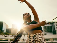 Young woman dancing because she's a Leo rising sign