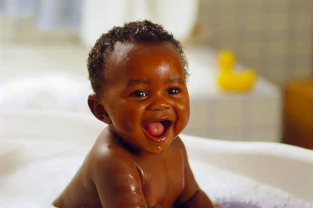 Baby boy smiling in the bathtub in an article about boy names that start with "M."