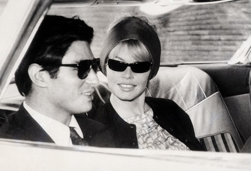 French film actors and lovers Brigitte Bardot and Sami Frey relax in a car together while she films ...