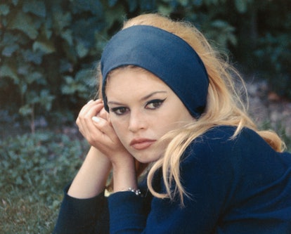 Brigitte Bardot wearing a black headband on set in 1963