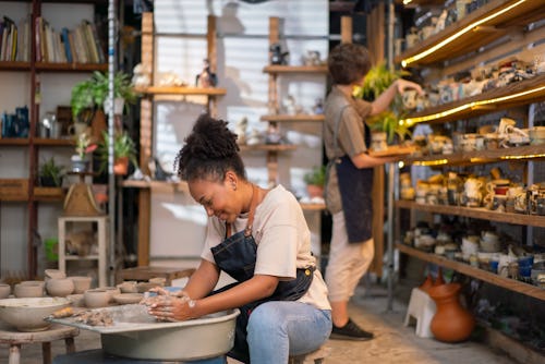 Young woman artist making clay bowl on pottery wheel. Here's the spiritual meaning of the july 2022 ...