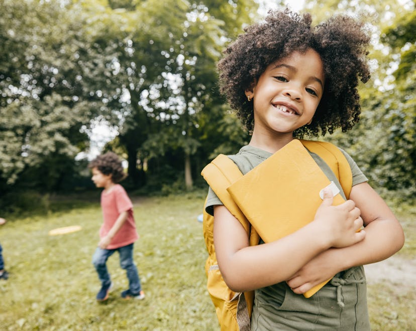 pair this shot of cute elementary school girl smiling and looking at camera with an adorable first d...