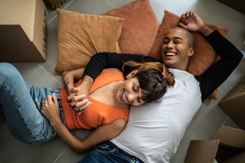 Happy young couple lying on the floor at new home. Here's your july 25 zodiac sign daily horoscope.