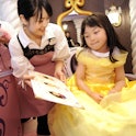 A girl chooses her hair style at salon "Bibbidi Bobbidi Boutique." Cast members who work at the salo...