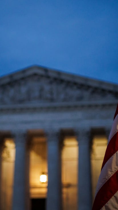 An abortion rights activist flies an upside down US flag, the international sign of distress, outsid...