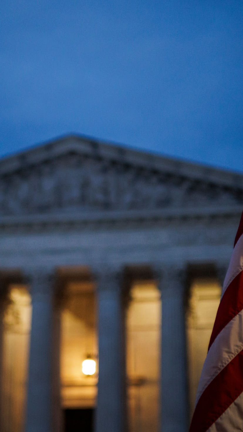 An abortion rights activist flies an upside down US flag, the international sign of distress, outsid...