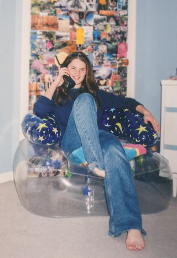 Vintage 1990s teen wearing Y2K fashion, 2000s style, inside teenage bedroom. Young woman talking on ...