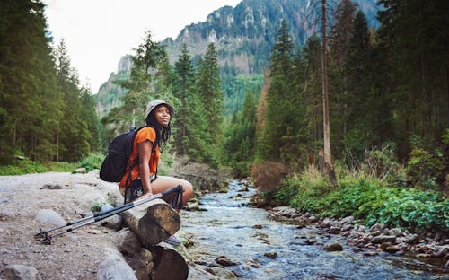 Shot of a young woman hiking in nature. These are the 4 most independent zodiac signs.