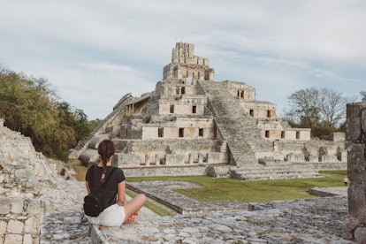 Main temple at the Mayan archeological site of Edzna in the state of Campeche, Mexico and woman tour...