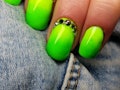 A closeup of green neon bright summer nails.
