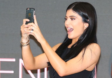 MELBOURNE, AUSTRALIA - NOVEMBER 18:  Kylie Jenner takes a selfie on her phone as Kendall Jenner and ...