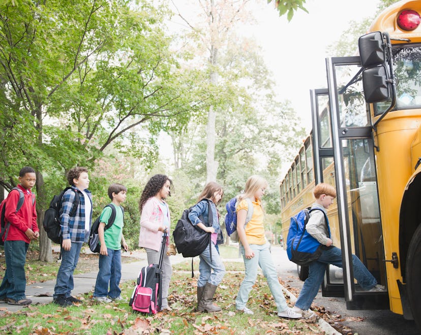 Children lined up to enter their school bus.