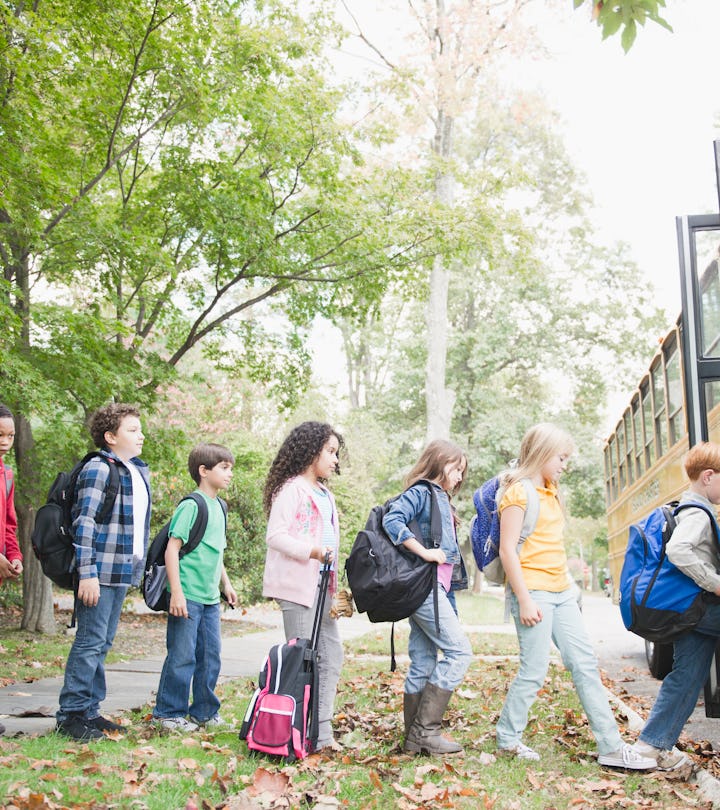 Children lined up to enter their school bus.