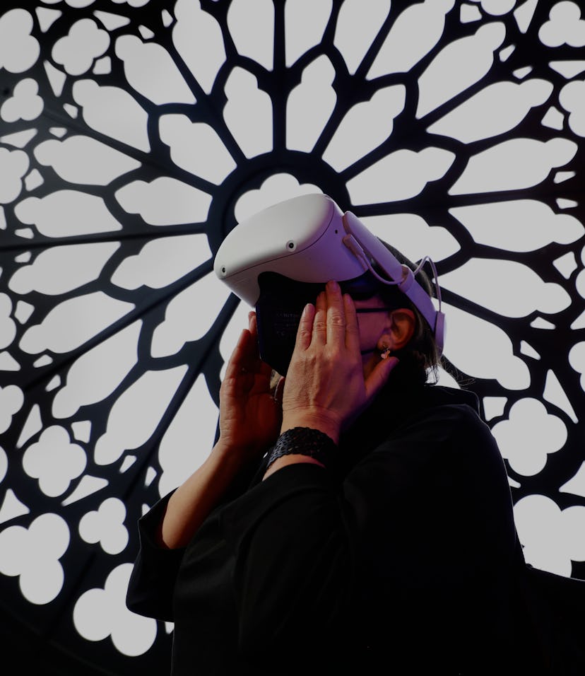 A congress attendant visiting the cathedral Notre Dame de Paris with the Meta Oculus Quest 2 headset...