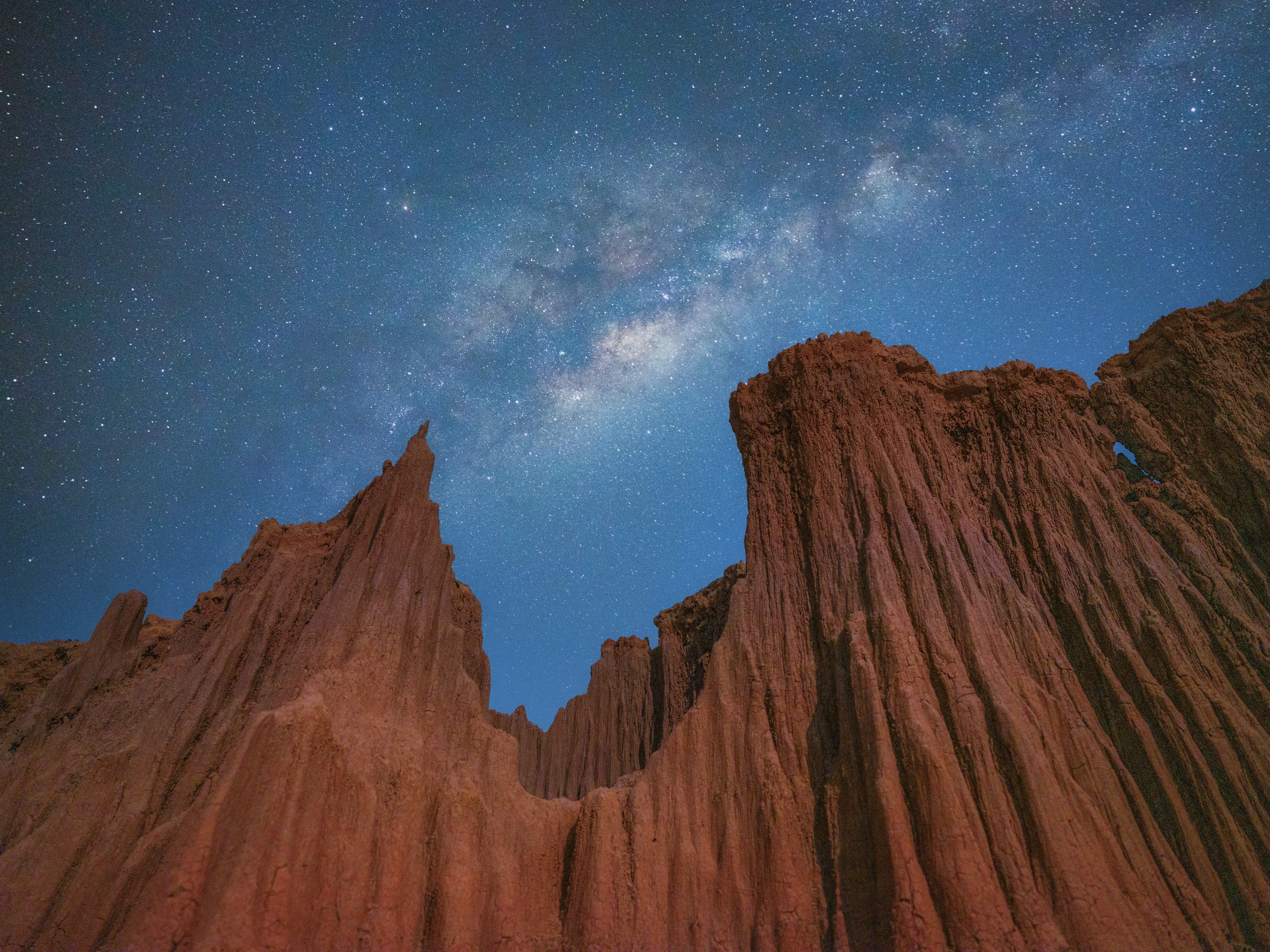 Grand canyon cliff erosion hill of soil with Milky way. Jupiter retrograde 2022.