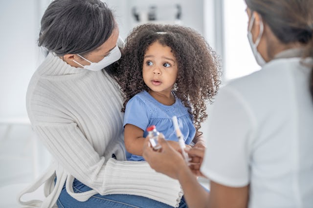 Millions of children are unvaccinated against COVID-19 ahead of new school year. Here, A female doct...