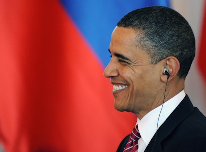 US President Barack Obama smiles as he seats to have lunch with his Russian counterpart Dmitry Medve...