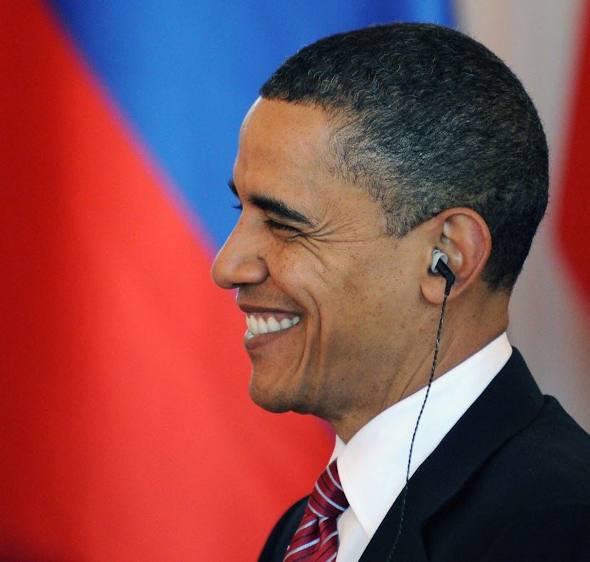 US President Barack Obama smiles as he seats to have lunch with his Russian counterpart Dmitry Medve...