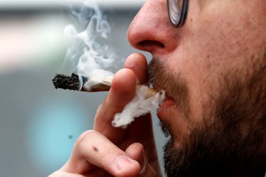A man smokes marijuana.