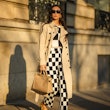 PARIS, FRANCE - NOVEMBER 10: Gabriella Berdugo wears a beige trench long coat from Trench London, a ...