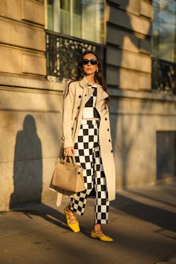 PARIS, FRANCE - NOVEMBER 10: Gabriella Berdugo wears a beige trench long coat from Trench London, a ...