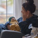 A mother stresses as she sits in a rocking chair with her newborn. In a new survey, 74% of women sai...