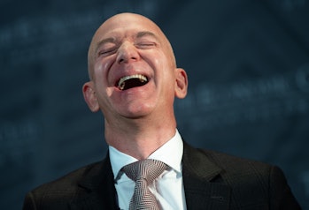 Jeff Bezos, founder and CEO of Amazon, laughs as he speaks during the Economic Club of Washington's ...