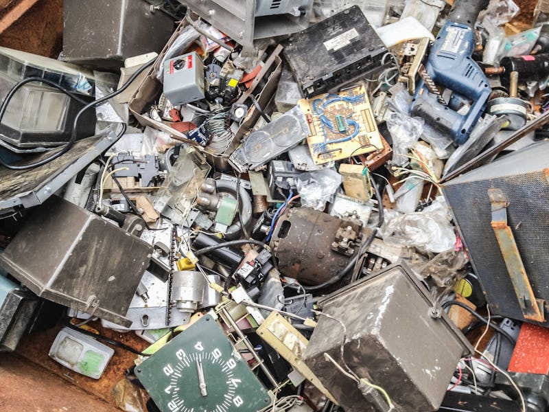 Discarded electronics in recycling bin.