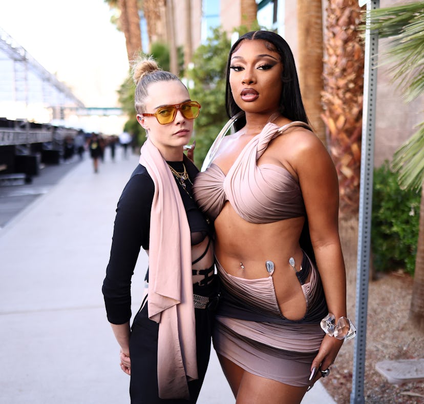 Cara Delevingne explained "odd" photos to Jimmy Fallon of her hyping up Megan Thee Stallion at the B...