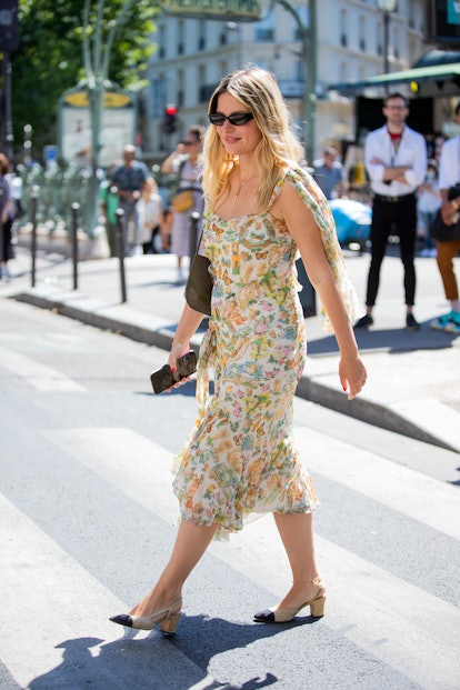 PARIS, FRANCE - JULY 04: Sabina Socol is seen wearing yellow dress with floral print, Chanel shooes ...