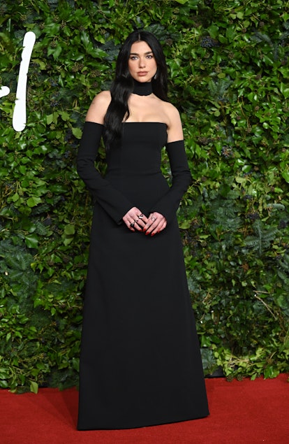 Dua Lipa wearing a black strapless gown at The Fashion Awards 2021.