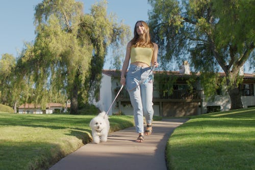 Woman walking her dog at the park. Here are three manifestation ideas for the July 2022 full Buck mo...
