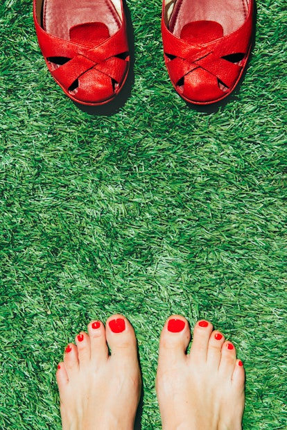 red toes on grass opposite red sandals