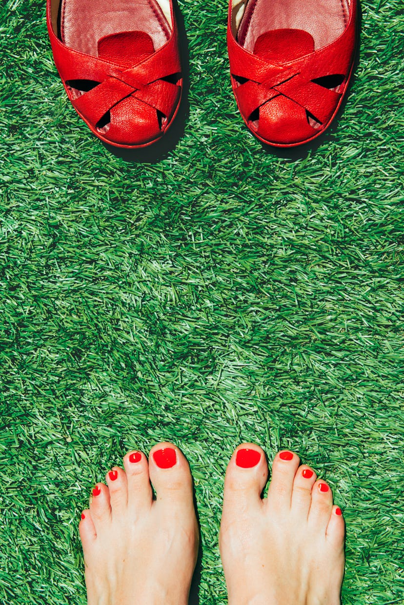 red toes on grass opposite red sandals