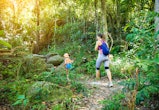 Woman and boy hiking in rainforest